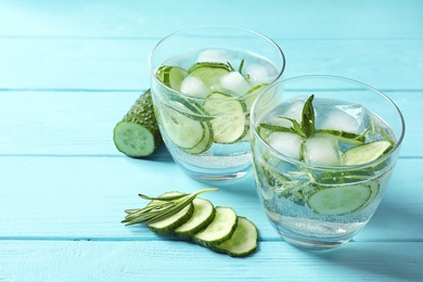 Photo of Natural lemonade with cucumber in glasses on wooden table