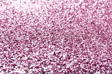 Photo of Texture of rose gold glitter as background, closeup