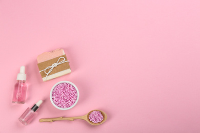 Photo of Flat lay composition with natural handmade soap on pink background. Space for text