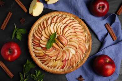 Flat lay composition with delicious homemade apple tart on black table