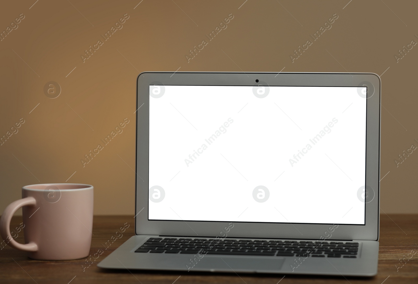 Photo of Laptop with blank screen on table indoors. Space for text