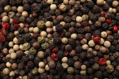 Aromatic spices. Different peppers as background, top view