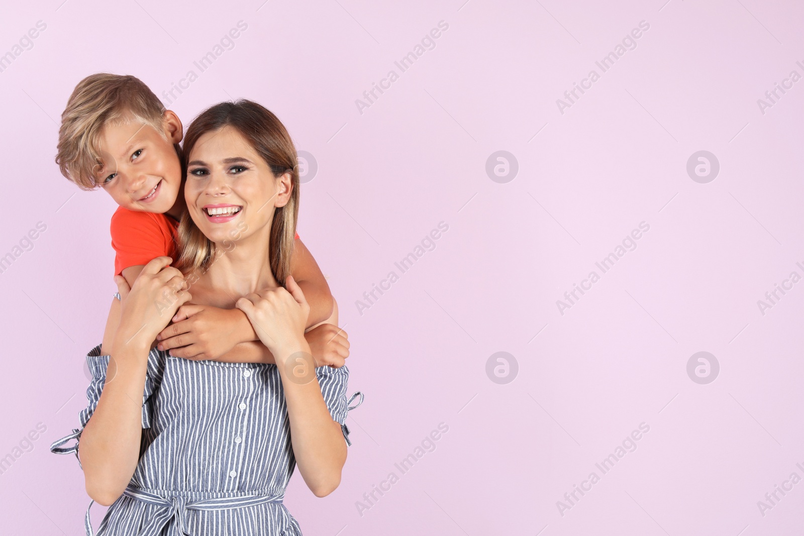 Photo of Portrait of mother and son on color background