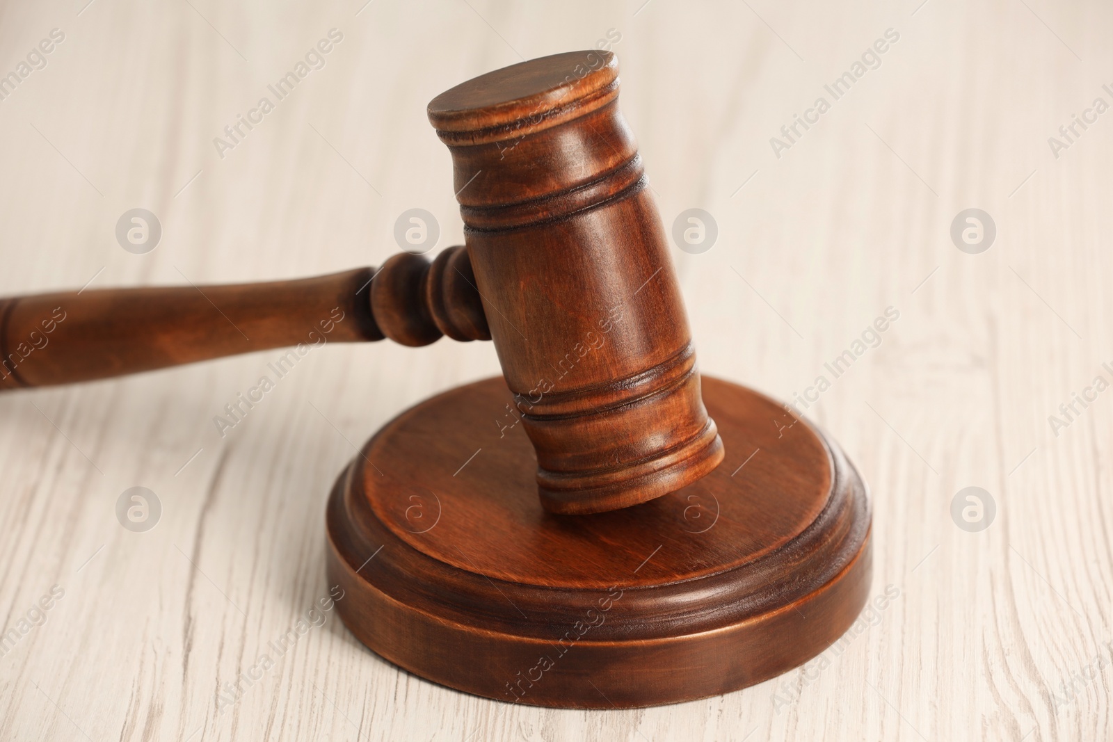 Photo of Law concept. Gavel on white wooden table, closeup