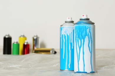 Used cans of spray paint indoors. Space for text