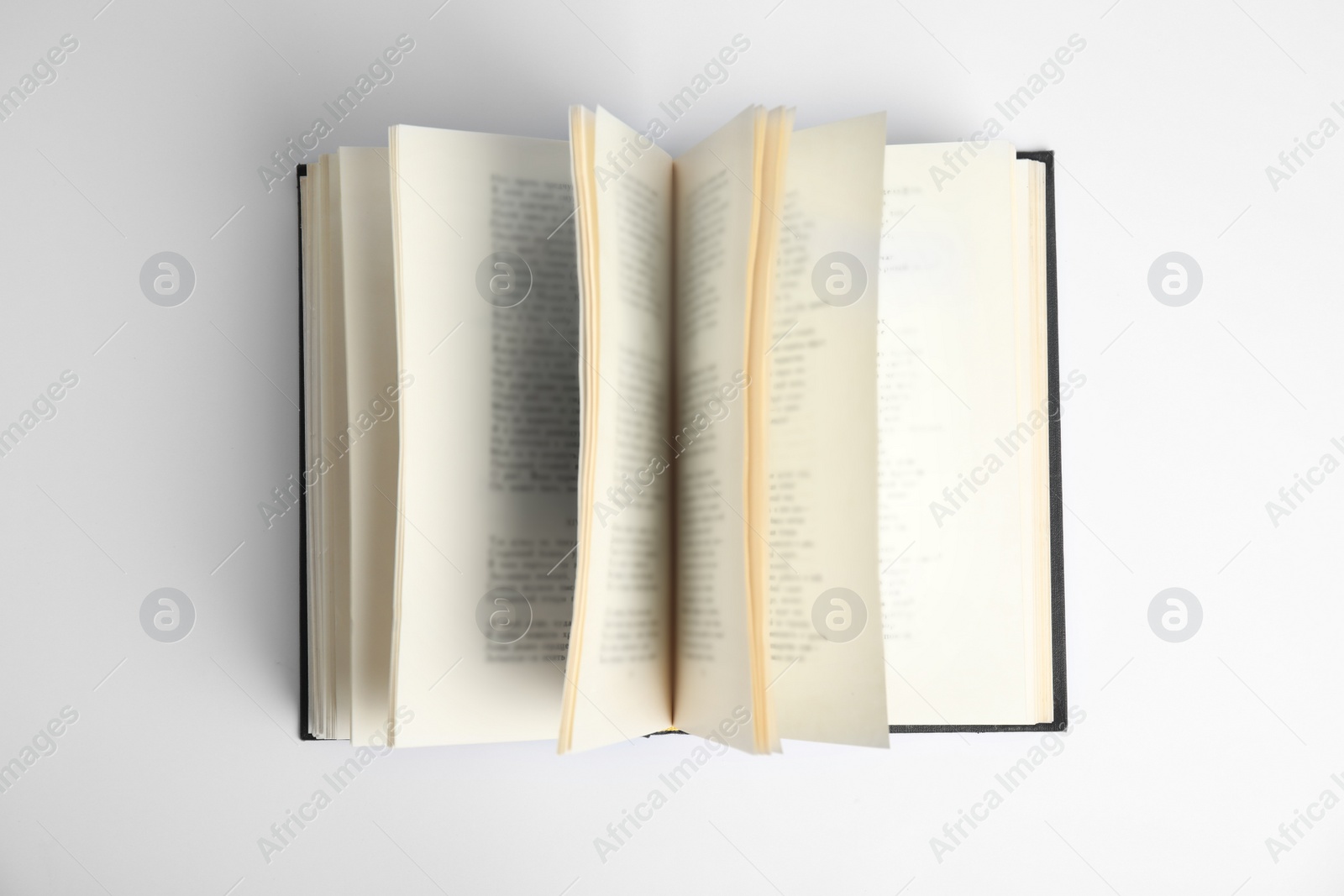 Photo of Open old hardcover book on white background, top view