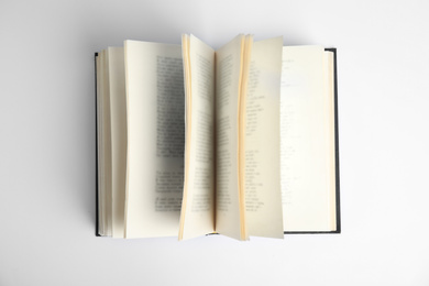 Open old hardcover book on white background, top view