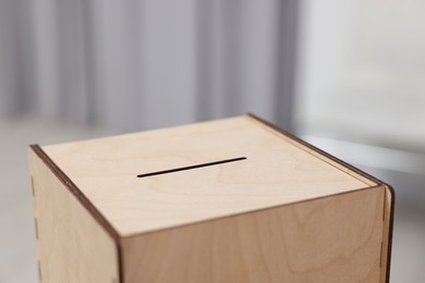 Photo of Wooden ballot box on blurred background, closeup