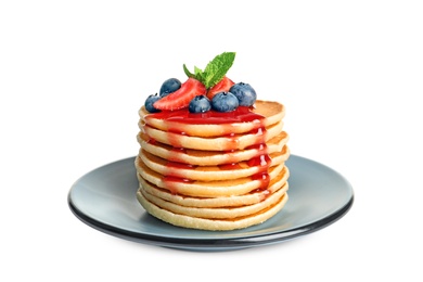 Photo of Plate with pancakes and berries on white background