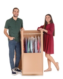 Photo of Young couple near wardrobe box on white background