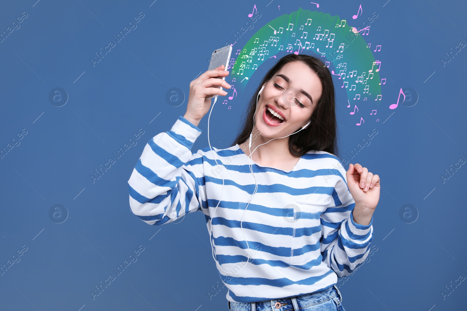 Image of Happy woman listening to music through headphones on blue background, space for text. Music notes illustrations flowing from gadget