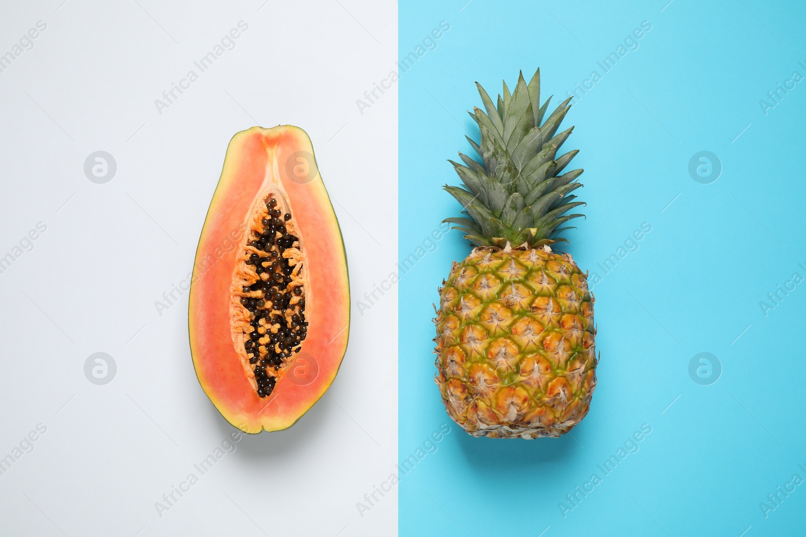 Photo of Fresh ripe papaya and pineapple on color background, flat lay