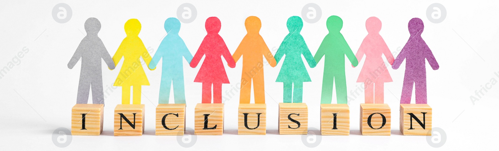 Image of Paper people figures and wooden cubes with word Inclusion on white background. Banner design