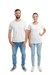 Photo of Young couple in t-shirts on white background. Mockup for design