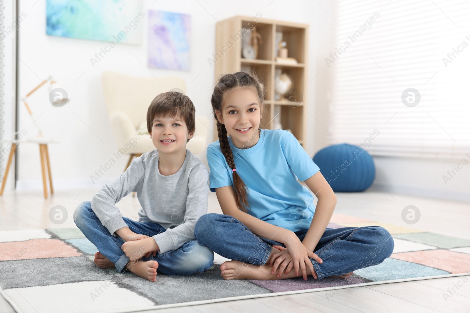 Photo of Happy brother and sister spending time together at home