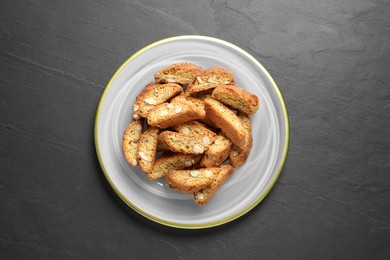 Photo of Traditional Italian almond biscuits (Cantucci) on grey table, top view