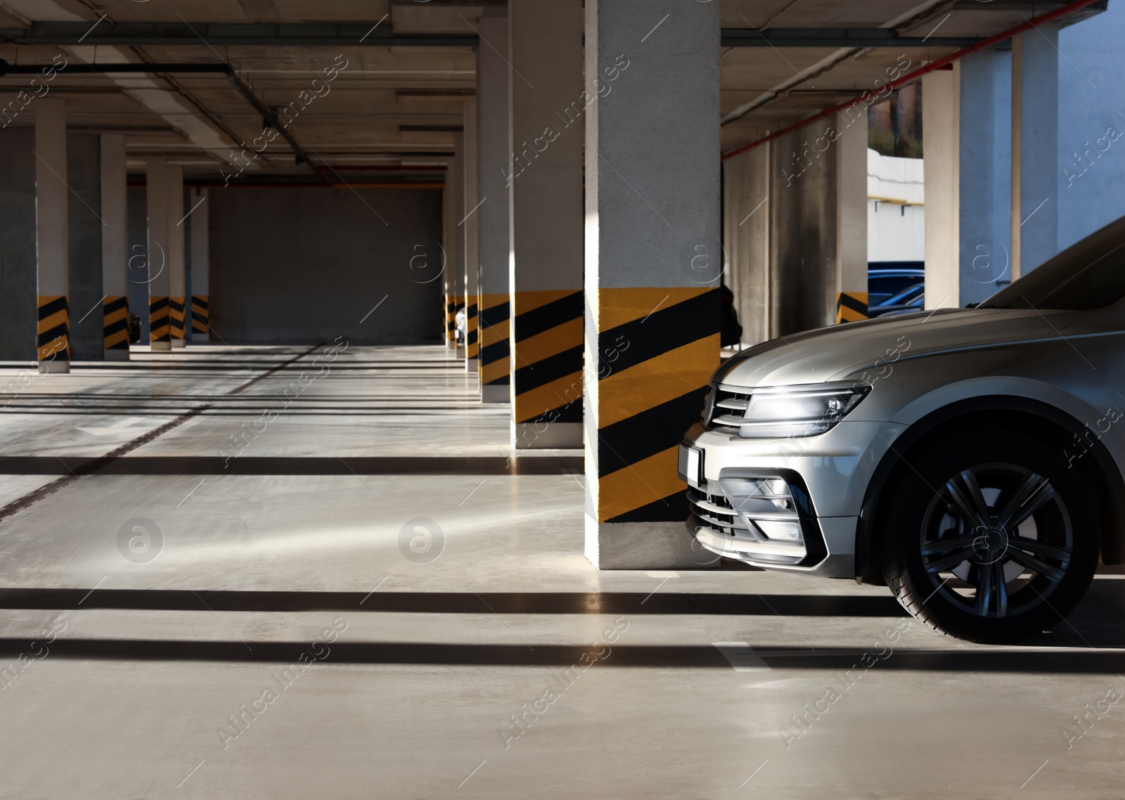 Photo of Open parking garage with car on sunny day