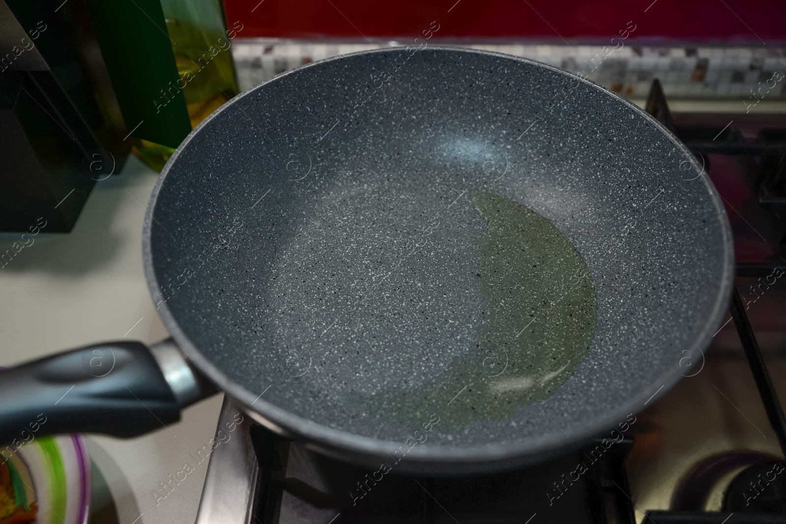 Photo of Frying pan with cooking oil on stove