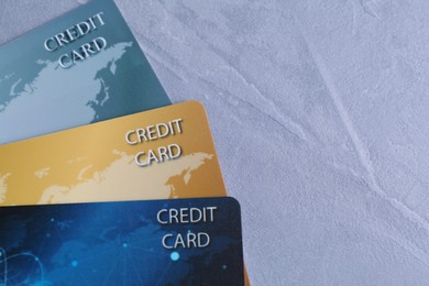 Photo of Credit cards on grey textured table, flat lay. Space for text