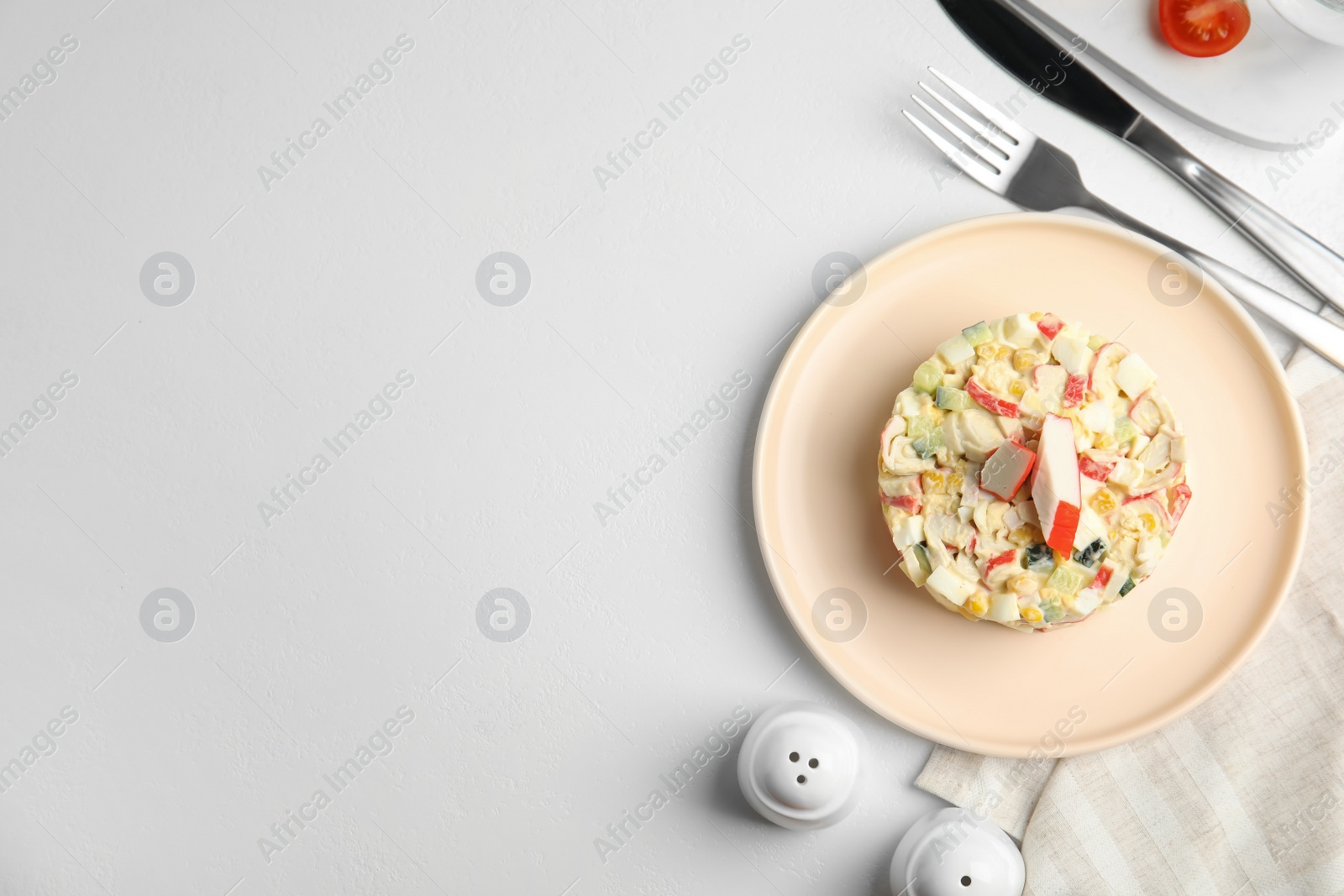 Photo of Delicious salad with crab sticks served on white table, flat lay. Space for text