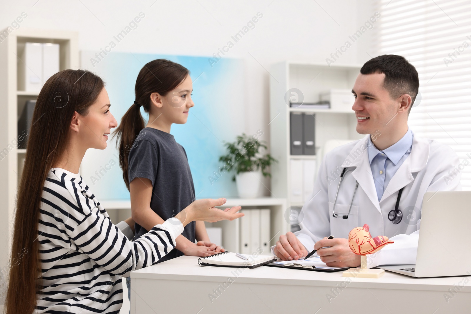 Photo of Gastroenterologist consulting woman and her daughter in clinic