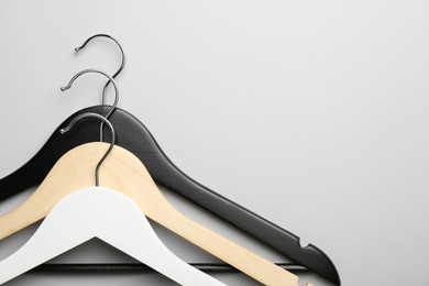 Hangers on light gray background, top view. Space for text