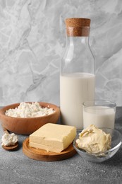 Photo of Piecetasty homemade butter and dairy products on grey table