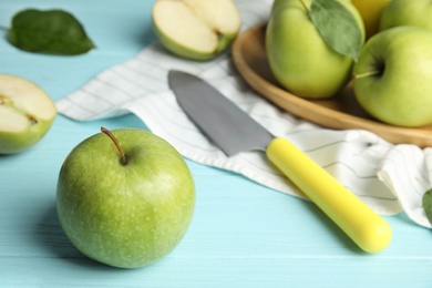 Composition with fresh ripe green apples on blue wooden table, space for text