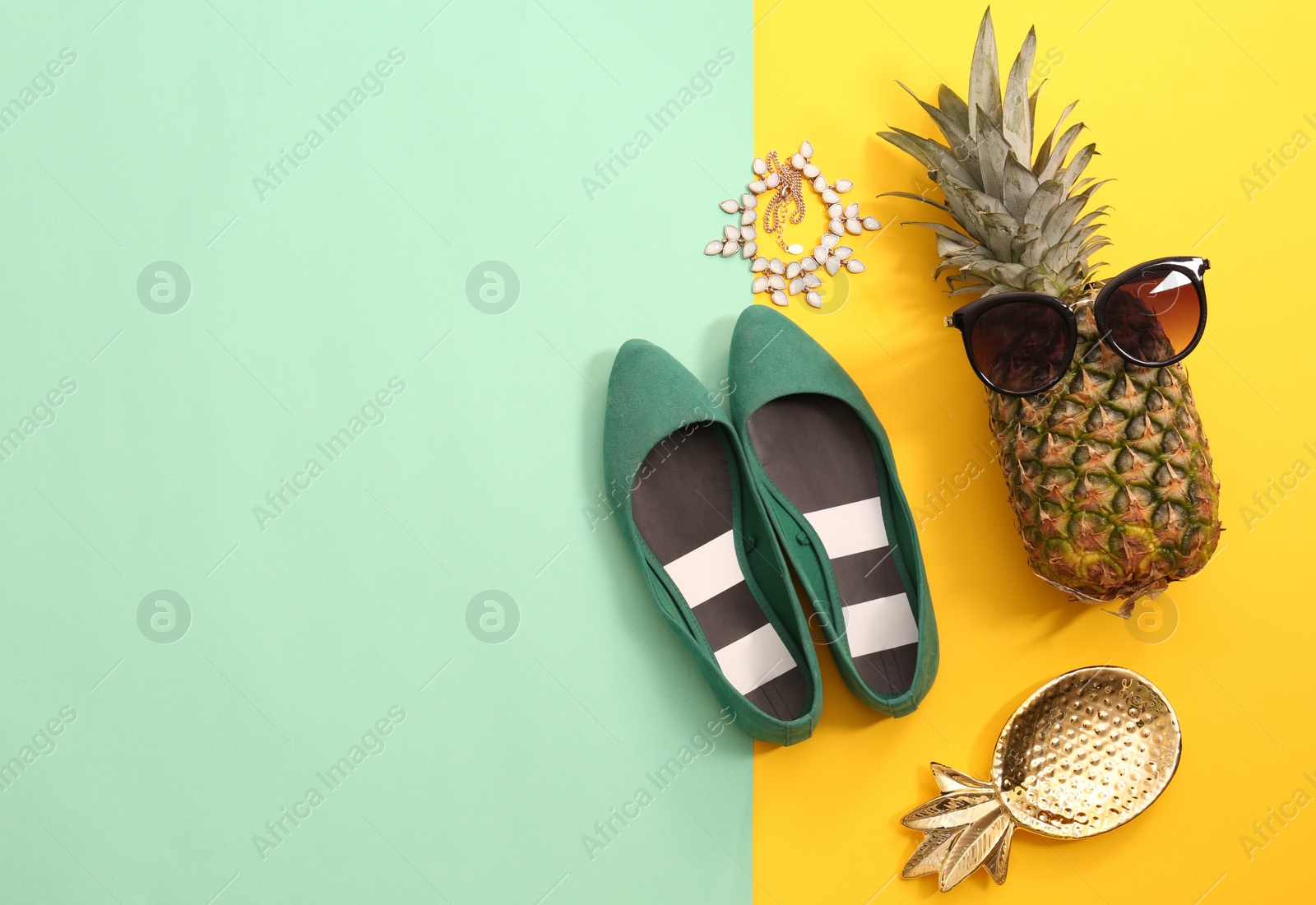 Photo of Flat lay composition with ripe pineapple, sunglasses and shoes on color background