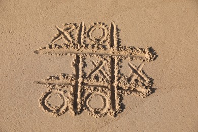 Tic tac toe game drawn on sandy beach
