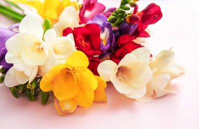 Photo of Beautiful freesia bouquet on color background