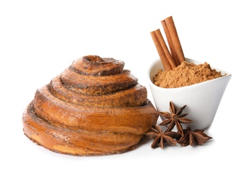 Photo of Freshly baked cinnamon roll with ingredients on white background