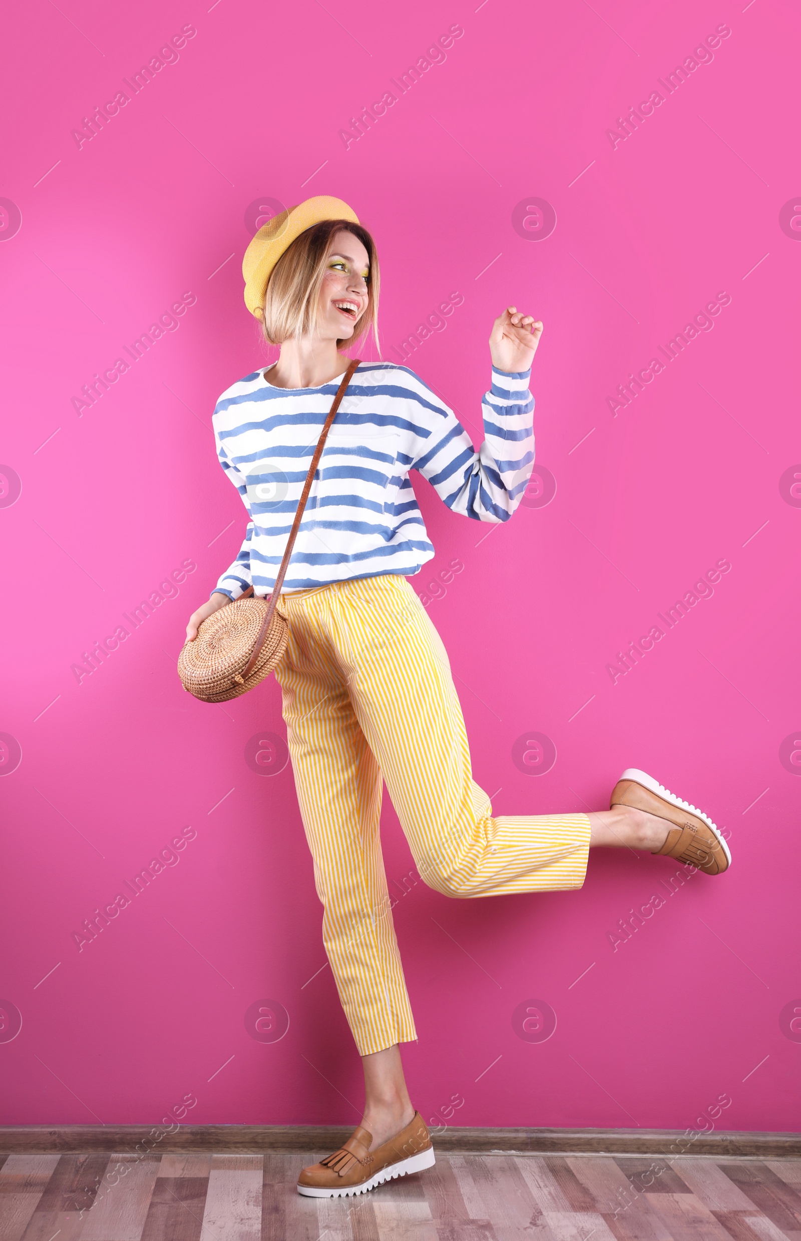 Photo of Beautiful young woman posing near color wall. Summer fashion