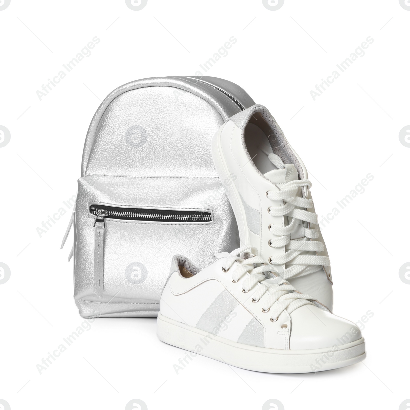 Photo of Pair of modern shoes and stylish backpack on white background