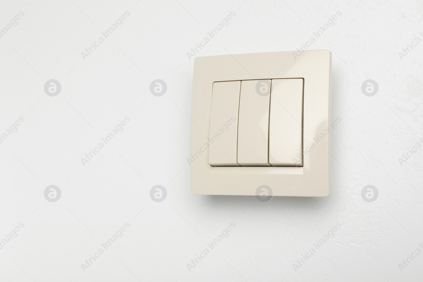 Photo of Modern light switch on white background. Space for text