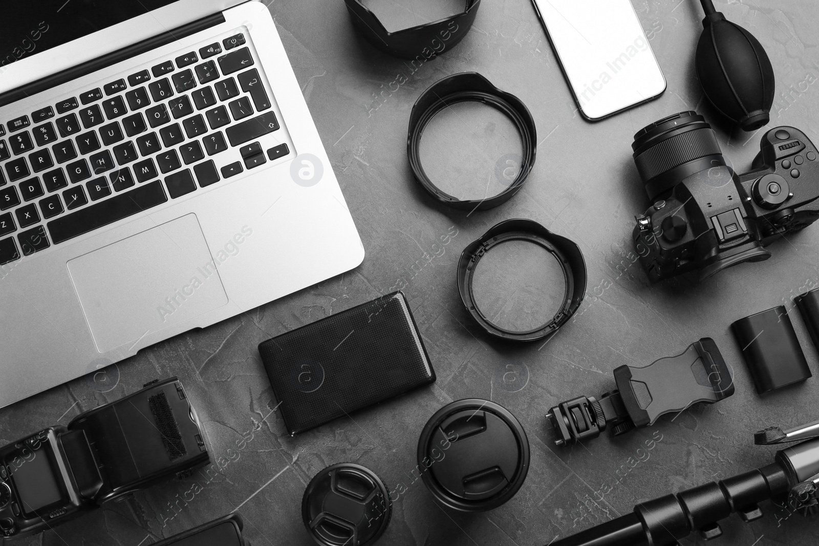 Photo of Flat lay composition with camera and video production equipment on grey stone background