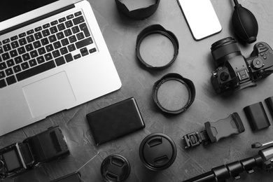 Flat lay composition with camera and video production equipment on grey stone background