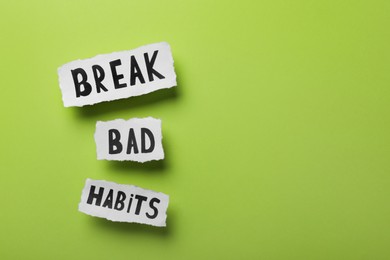 Photo of Phrase Break Bad Habits on green background, flat lay. Space for text