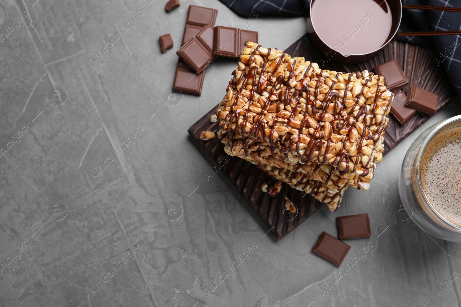 Photo of Delicious rice crispy treats on grey table, flat lay. Space for text