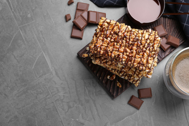 Photo of Delicious rice crispy treats on grey table, flat lay. Space for text