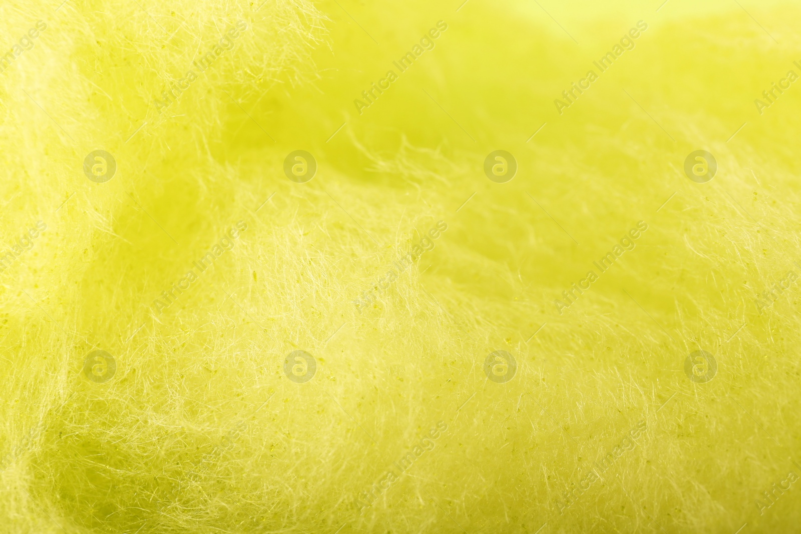 Photo of Sweet yellow cotton candy as background, closeup