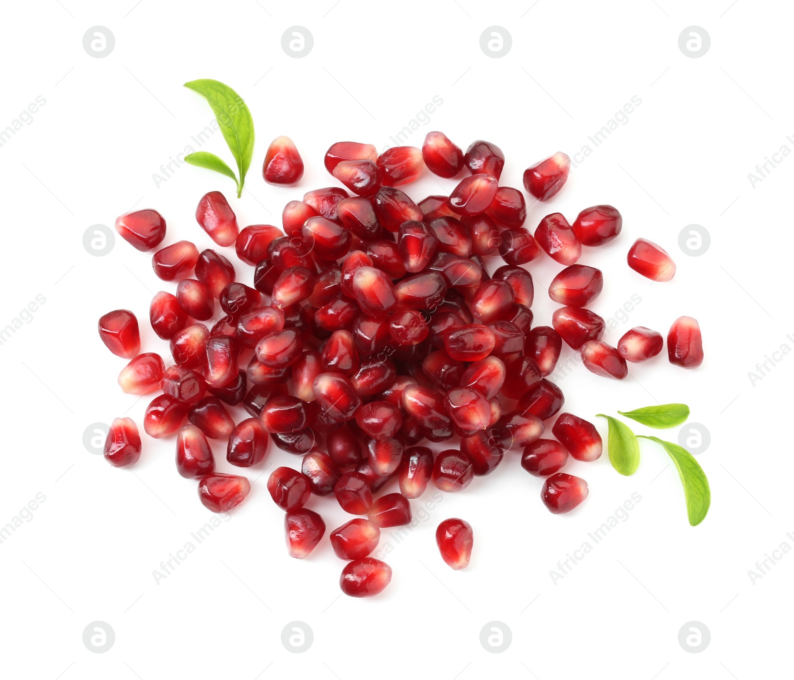 Photo of Pile of tasty pomegranate grains and leaves isolated on white, top view