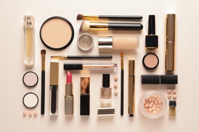 Photo of Different luxury makeup products on color background, flat lay