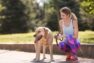 Young woman and her dog spending time together outdoors. Pet care