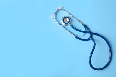 Photo of Stethoscope on color background, top view. Medical equipment