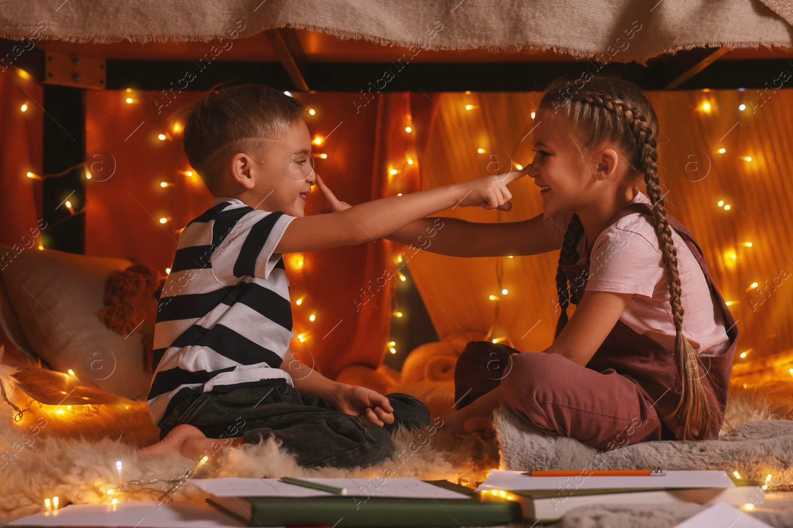 Photo of Children playing in play tent at home