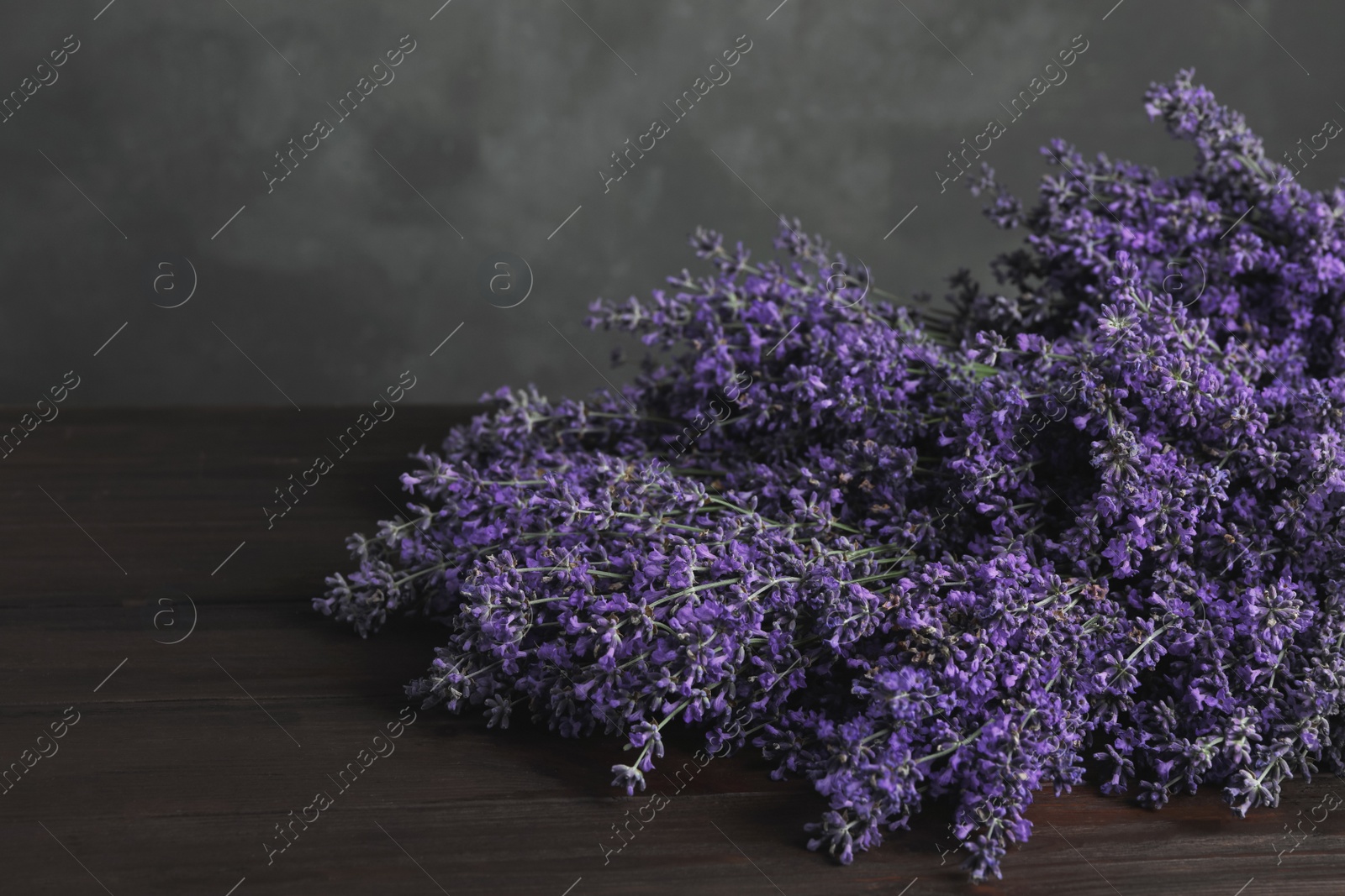 Photo of Beautiful fresh lavender flowers on wooden table, closeup