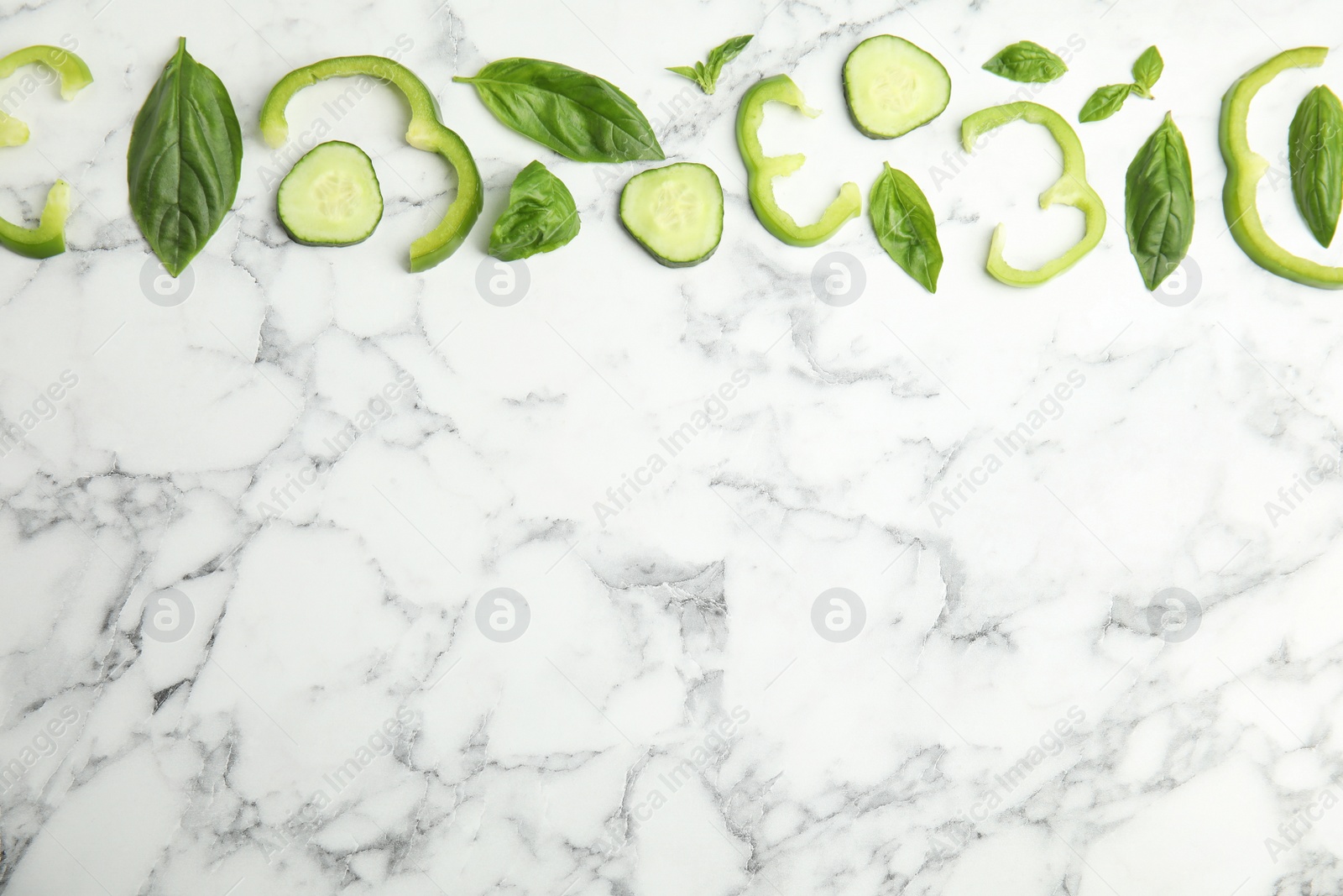 Photo of Flat lay composition with fresh salad ingredients on white marble table, space for text