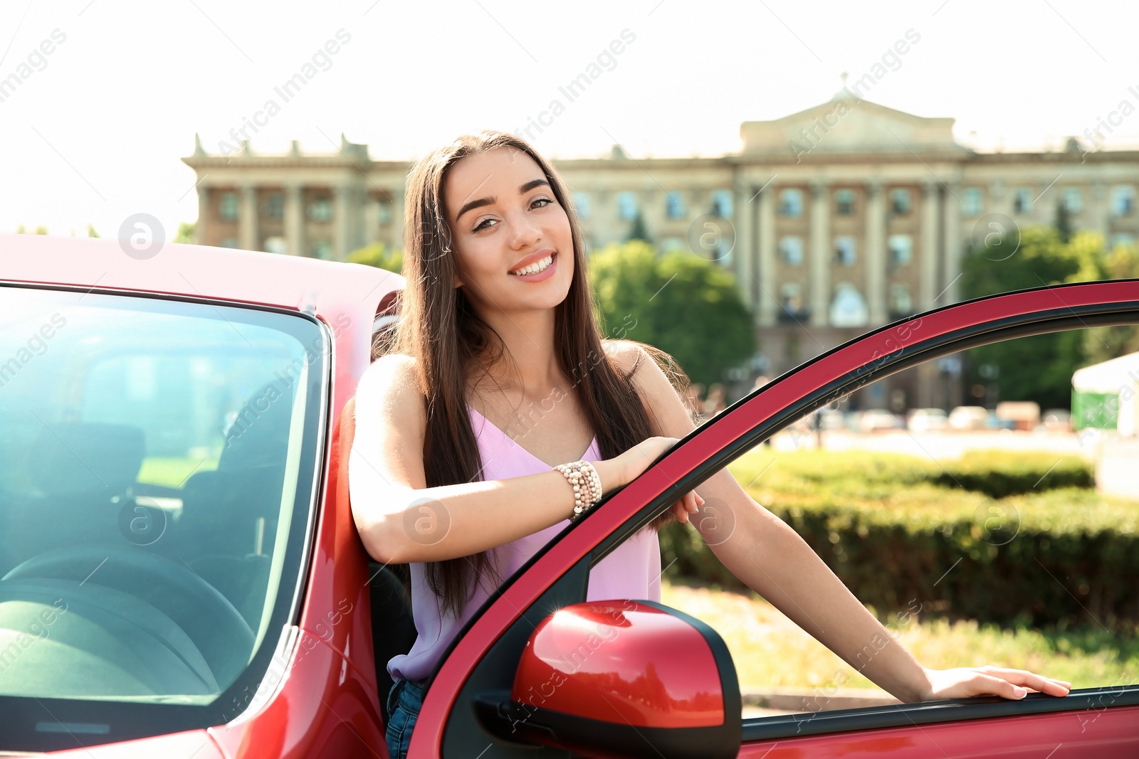 Photo of Young woman near car outdoors on sunny day