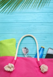 Photo of Flat lay composition with beach accessories on light blue wooden background, space for text